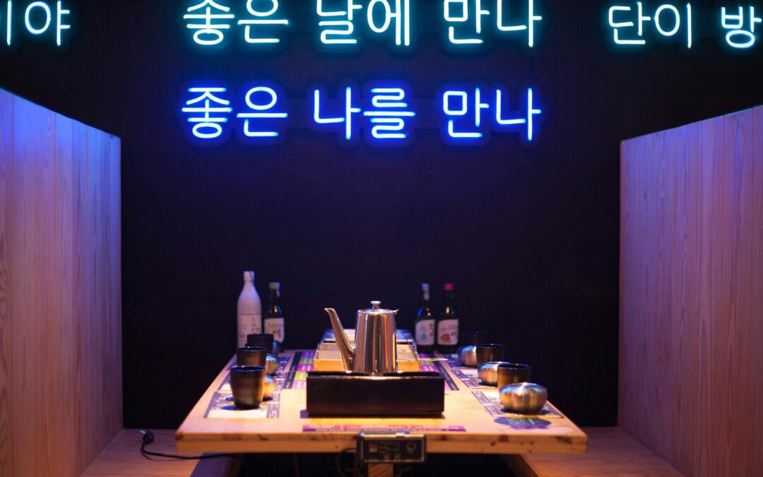 a restaurant booth with neon signs